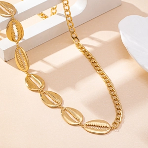 Fashionable gold shell body chain with Cuban link style for a luxury beach vacation look