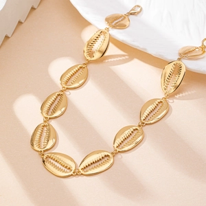 Elegant gold seashell body chain for women with polished metal ocean inspired link design