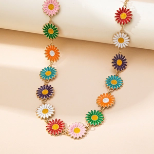 Bohemian colorful enamel daisy body chain with gold plating on a minimalist background