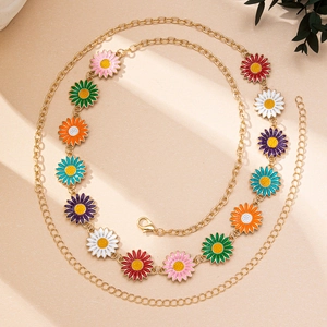 Detail of colorful enamel daisy charms on a gold bohemian style adjustable body waist chain