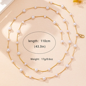 Detail showing elegant 110cm pearl body chain with gold links and lobster clasp