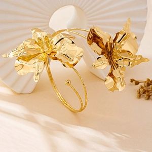 Exaggerated gold orchid upper arm cuff with irregular 3D metal flower design