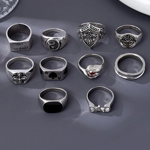 Flat lay of 10 vintage punk rings featuring spade, cross, and yin yang symbols