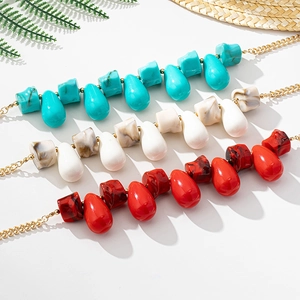 Detail of bohemian water drop beaded necklaces in turquoise, white marble and red