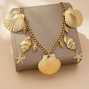 Gold ocean themed waist chain with starfish and shell pendants on a display stand