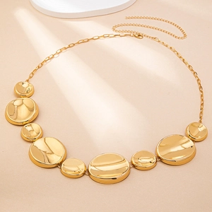 Close-up of polished gold-plated metal link waist chain with adjustable lobster clasp