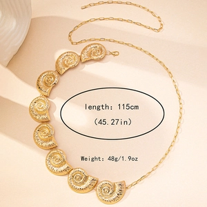 Detail of golden seashell and conch charms on a 115cm adjustable metal waist chain