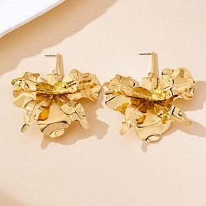 Detailed view of 3D layered golden petal stud earrings with elegant satin finish