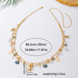 Detail of ocean-themed gold chain with enamel starfish and shells for beachwear