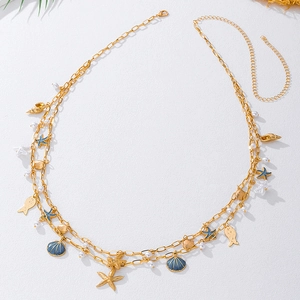 Detailed view of ocean theme waist chain with gold charms, starfish, shells and pearls