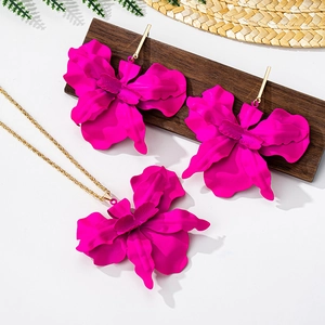 Detail of rose red floral jewelry set with matte orchid necklace and long hook earrings