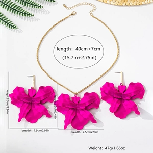 Detailed view of magenta orchid necklace and earrings set with gold adjustable chain