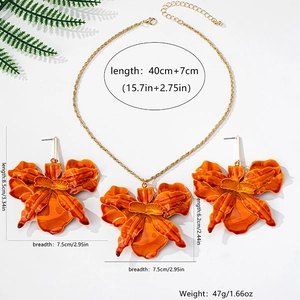 Detail shot of orange orchid floral jewelry set with detailed size dimensions