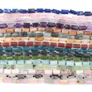 Cylindrical lapis lazuli and mixed natural gemstone beads strands on white background