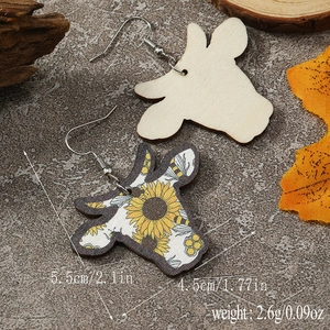 Macro view of bull head wooden earrings with sunflower and bee prints showing dimensions