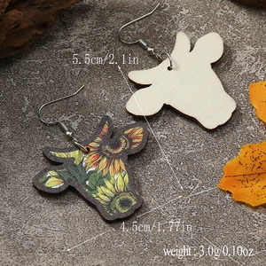 Detail of cow head wooden earrings with sunflower pattern including size and weight specs