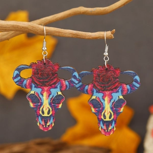 Bohemian bull skull earrings with red rose pattern on wooden texture with metal hooks