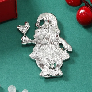 Macro shot of the silver alloy brooch back with pin clasp on a festive green background