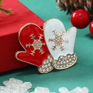 Detailed close-up of Christmas glove brooches with oil drip enamel and sparkling rhinestones