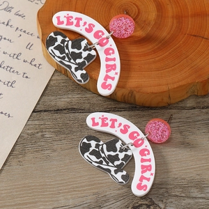 Acrylic cow print cowboy hat earrings with Let's Go Girls text on rustic wood background