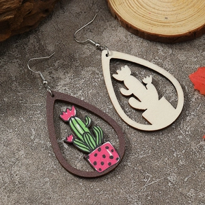 Detailed view of handmade teardrop wooden earrings featuring colorful cactus cutout design