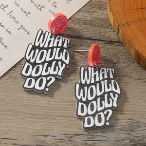 Detail of pink glitter studs and acrylic pendant with What Would Dolly Do lettering