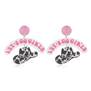 Detail of pink glitter studs and cow print cowboy hat charms on Western acrylic earrings