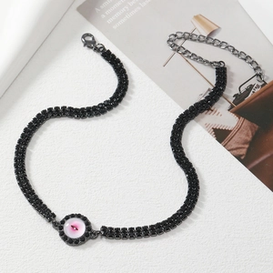 Detail of double-strand black crystal necklace with pink evil eye pendant and clasp