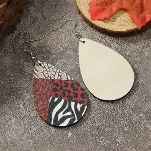 Detail of teardrop wood earrings with mixed animal prints and natural wood grain back