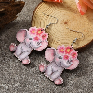 Detail shot of cute cartoon elephant wood earrings with pink flowers and a smooth print finish