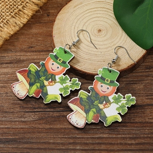 Detail of St. Patrick's Day wooden drop earrings with cartoon leprechaun and mushroom