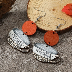 Detail view of coffee cup wooden earrings with leopard print and Hot Milk text