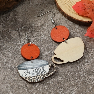 Close-up of wooden coffee cup earrings featuring leopard print and Hot Milk 60ml design