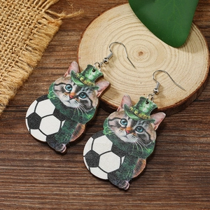 Detail of wooden drop earrings with cartoon cat, soccer ball and St. Patrick's Day green hat