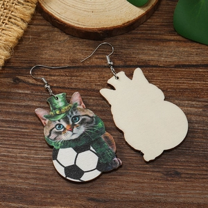 Close-up of wood earrings with cute cat, green glitter hat and soccer ball graphics