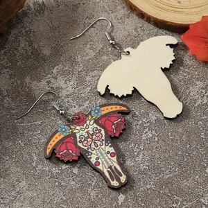 Detailed close-up of bohemian wood earrings with colorful skull and floral patterns