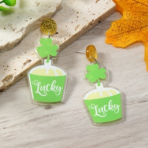 Detail of St. Patrick's Day acrylic earrings with Lucky shamrock and gold glitter studs
