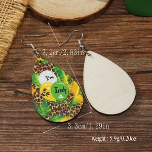 Detail of wooden drop earrings featuring leopard print and Irish Kiss Me text for St. Patrick