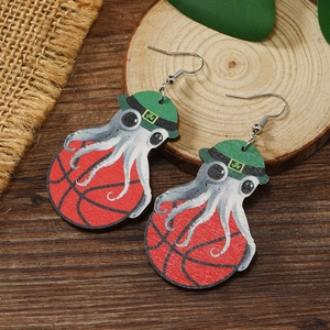 Detail of handmade wooden hook earrings featuring an octopus with clover hat and basketball