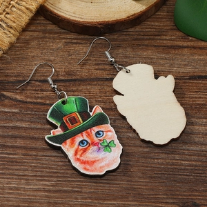 Detailed view showing the orange cat design and natural wood back of the clover earrings