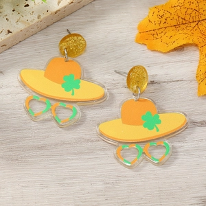 Detail of St. Patrick's Day acrylic earrings with shamrock hat and heart sunglasses