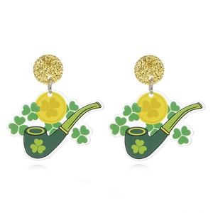 Macro detail of acrylic St. Patrick's Day earrings with green pipe and clover motifs