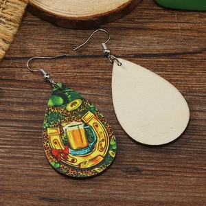 Detail of teardrop wooden earrings with clover, horseshoe and leopard print patterns