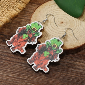 Close-up of Saint Patrick's Day wooden earrings featuring a dog in a green Irish hat