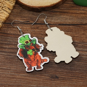 Detail of wooden dachshund earrings featuring festive green hat and clover print for St. Patrick