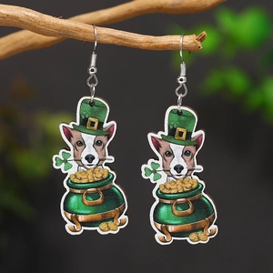 St. Patrick's Day dog in gold pot earrings on wooden branch with green nature background