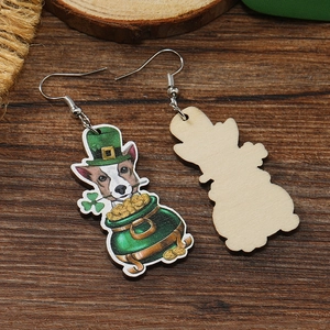 Detail of wooden St. Patrick's Day earrings with green clover and gold coin dog designs
