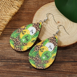 Detail of wooden teardrop earrings with Irish festive balloons and green clover prints