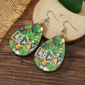 Macro detail of St. Patrick's Day wooden teardrop earrings with Lucky clover and beer prints