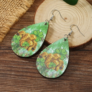 Close-up of teardrop wooden earrings with Saint Patrick's Day clover and gold coin print